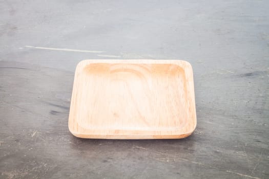 Wooden plate on grey background, stock photo