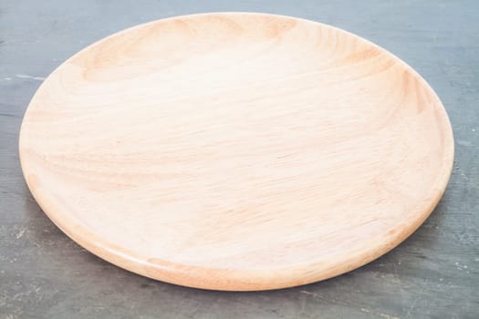 Wooden plate on grey background, stock photo