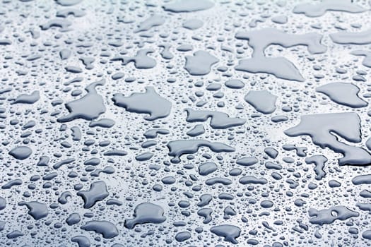 On a rainy day,puddles of water form on a car