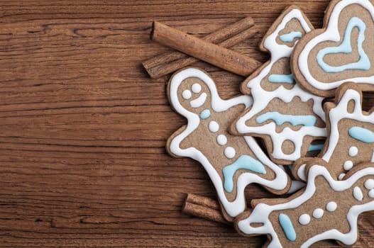 Tray of decorated gingerbread cookies with cinnamon sticks