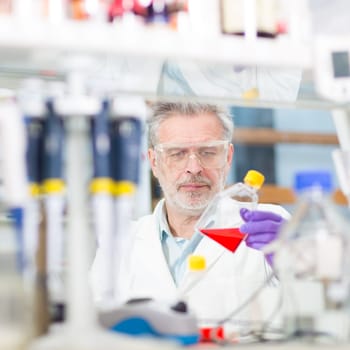 Life scientist researching in laboratory. Life sciences study living organisms on the level of microorganisms, viruses, human, animal and plant cells, genes, DNA...