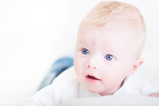 Cute blonde little baby boy with blue eyes.