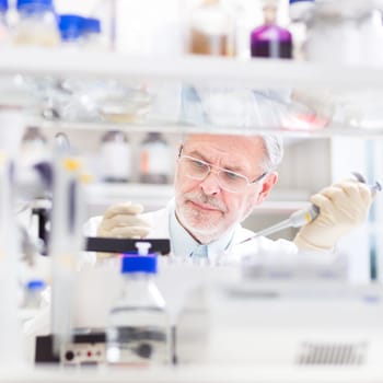 Life scientist researching in laboratory. Life sciences study living organisms on the level of microorganisms, viruses, human, animal and plant cells, genes, DNA...