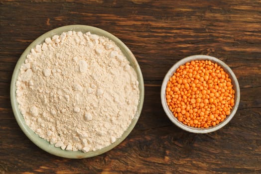 Red lentils and lentil flour in small potted bowls
