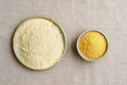 Millet and millet flour in small potted bowls