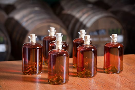 Just bottled liquor with barrels in the background