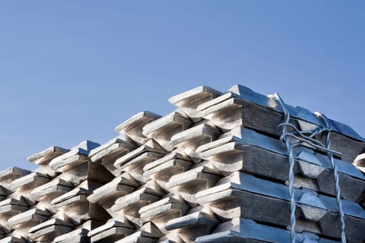 Shiny aluminum ingots and a blue sky