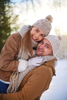 Cheerful dates in winterwear spending time together outdoors