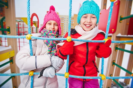 Two girls in winterwear having fun outdoors