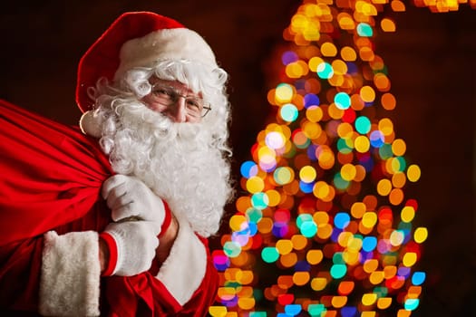 Santa Claus holding big sack with gifts