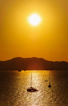 Seascape, The sunset colorful with boat and light flare technique