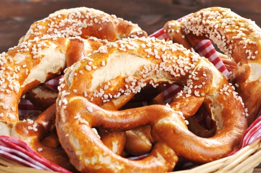 original Bavarian lye pretzels with salt in a basket on wooden boards