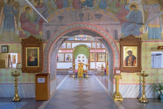 Archway to iconostasis and altar through halls of worship in church.