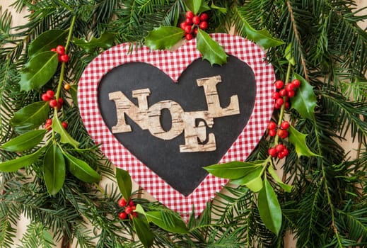 Rustic background for Christmas with fir branches and holly