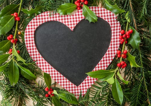Rustic background for Christmas with fir branches and holly