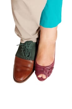 A closeup picture of the feet and shoe's of a woman and a man site.by site, isolated for white background..