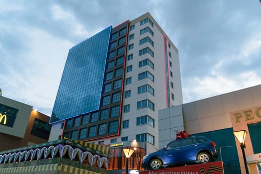 The modern 5-star hotel, a multifunctional tourist complex "MegaGRINN"" in Orel (Russia) against the evening sky."