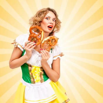 Beautiful sexy shocked Oktoberfest woman wearing a traditional Bavarian dress dirndl holding two pretzels and feeling scared on colorful abstract cartoon style background.