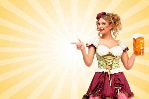 Beautiful smiling sexy Oktoberfest waitress wearing a traditional Bavarian dress dirndl holding beer mug, and pointing aside on colorful abstract cartoon style background.