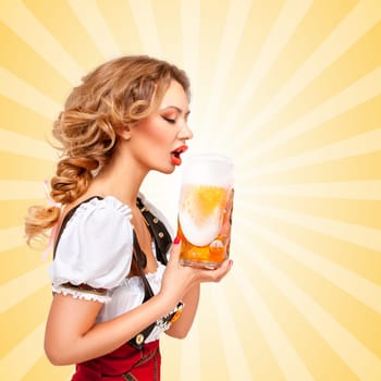 Beautiful thirsty sexy woman wearing red jumper shorts with suspenders as traditional dirndl, drinking from a beer mug on colorful abstract cartoon style background. Side view.