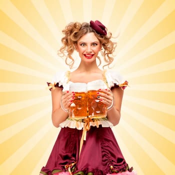 Beautiful sexy Oktoberfest waitress, wearing a traditional Bavarian dress dirndl, serving two big beer mugs in a tavern and smiling on colorful abstract cartoon style background.