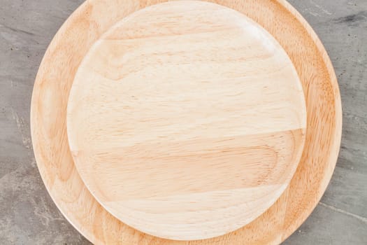 Wooden plate on grey background, stock photo