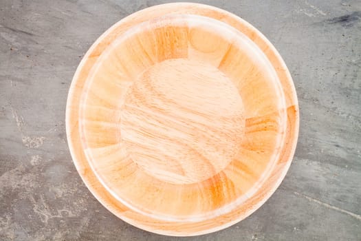 Wooden plate on grey background, stock photo