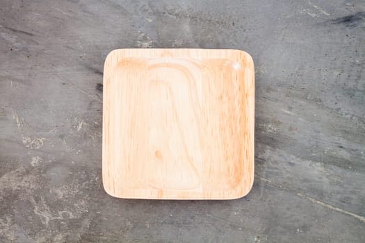 Wooden plate on grey background, stock photo