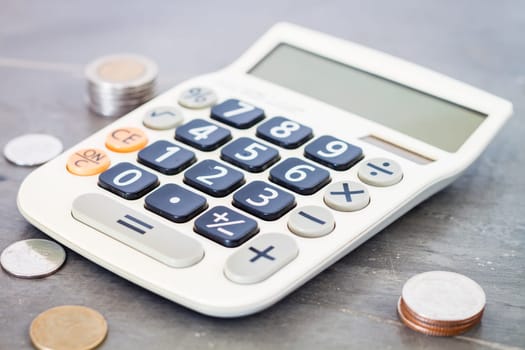 Calculator with money on grey background, stock photo