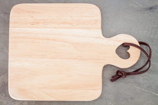 Wooden plate on grey background, stock photo