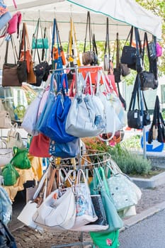 Women's handbags for sale at an outdoor market