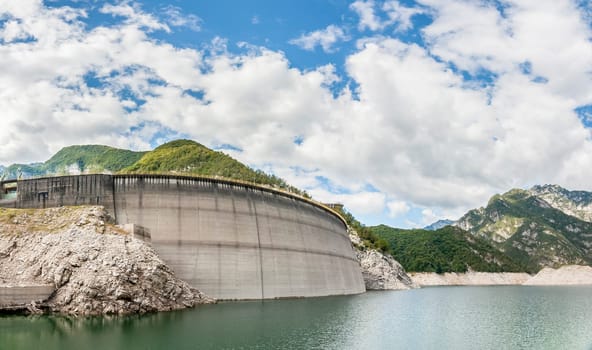 Landscape with dam for the production of electrical energy in the mountains
