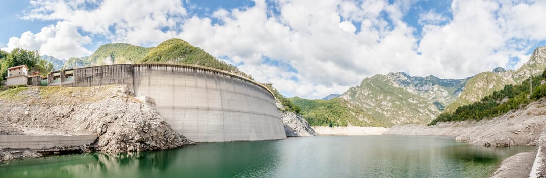 Landscape with dam for the production of electrical energy in the mountains