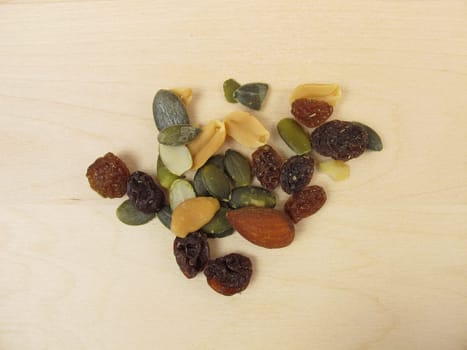 Nuts,seeds and raisins on a wooden background