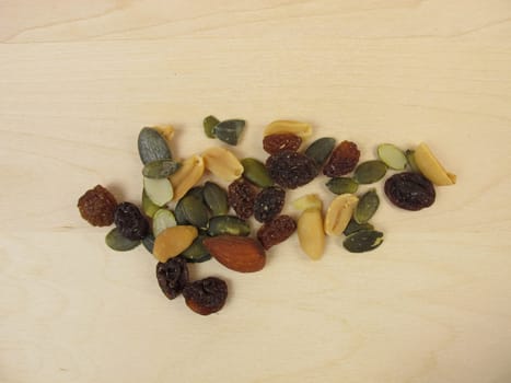 Nuts,seeds and raisins on a wooden background