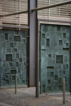 Mainz,Germany – September 04,2015: Hanging copper printing plates with various motifs and characters in the courtyard of the Gutenberg Museum on September 4,2015 in Mainz.