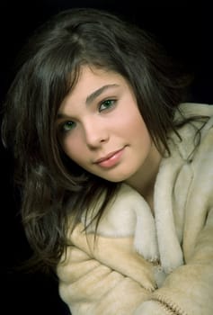 young beautiful brunette portrait against black background