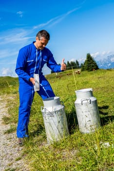 Herdsman standing in front of cattle in farm