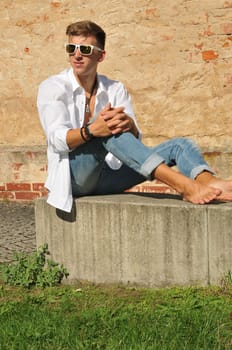 Good-looking young man posing in nature,stylish,modern