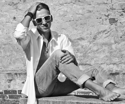 Good-looking young man posing in nature,stylish,modern