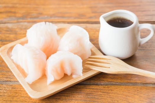 Chinese har gao dim sum dumplings on wooden plate, stock photo