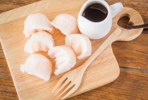 Chinese har gao dim sum dumplings on wooden plate, stock photo