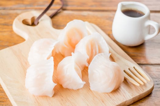 Chinese har gao dim sum dumplings on wooden plate, stock photo