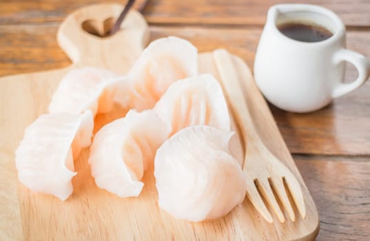 Chinese har gao dim sum dumplings on wooden plate, stock photo