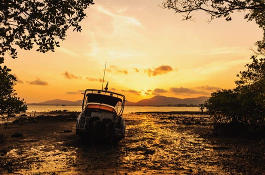 Boat on the beach with color of sunset, Phuket thailand