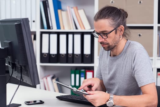 creative man is working in his office with different computer