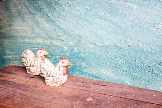 Chicken dolls with vintage green concrete background, stock photo