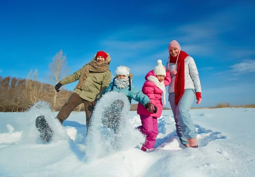 Ecstatic family having fun in snowdrift
