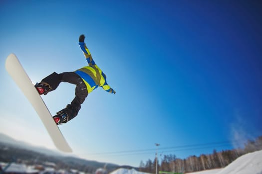 Man on snowboard enjoying extreme kind of sport on winter resort