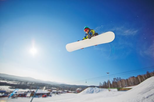 Sportsman on snowboard spending winter vacation on resort